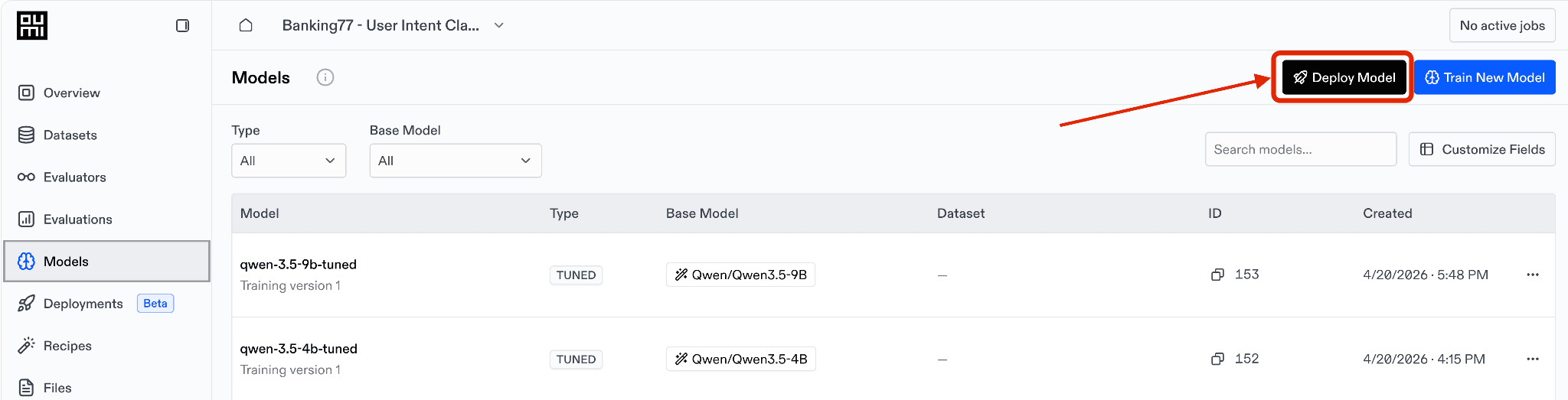 Models page of the Oumi Platform for the Banking77 project, listing tuned Qwen3.5-9B and Qwen3.5-4B models, with the Deploy Model button in the top right highlighted by a red box and arrow.
